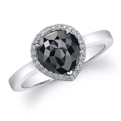 A single rose cut pear shaped black diamond weighting , sits surrounded by a halo of sparkling white diamonds in this unique 14k white gold ring. This fabulous look is the latest trend worn by many celebrities.