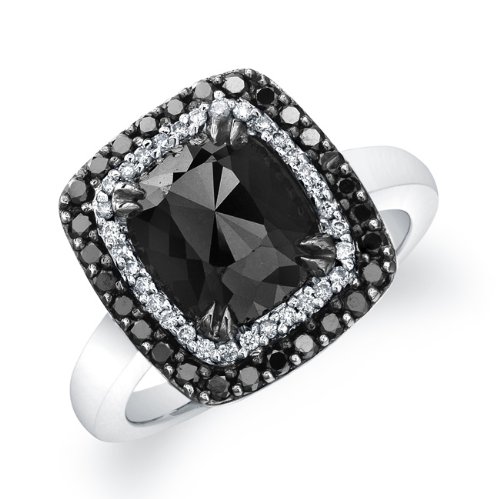 A single rose radiant shaped black diamond weighting 1 1/4 ct, sits surrounded by a halo of 50 sparkling white & black diamonds totaling1/3 ctw. in this unique 14k white gold black diamond ring. This fabulous look is the latest trend worn by many celebrities.